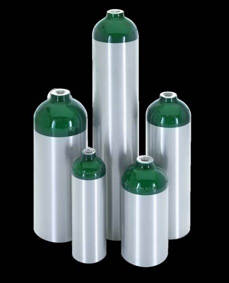 Five silver gas cylinders with green tops